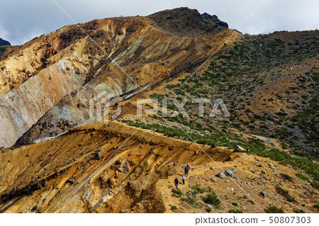 Mountain climbers on the Adatara mountain and Numanohira crater wall 50807303