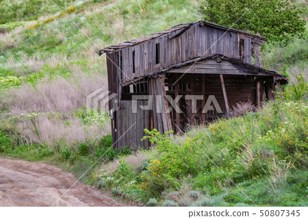 Old abandoned wooden rural hut in countryside 50807345