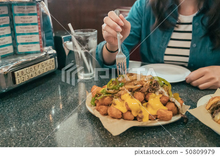 woman eating fast food and drinking soda woman eating fast food and drinking soda 50809979