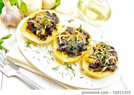 Potatoes stuffed with mushrooms on board 50811305
