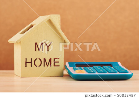 House and calculator on desk for financial concept House and calculator on desk for financial concept 50812487