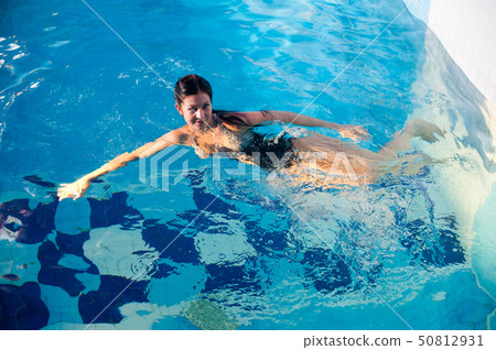 Attractive girl in swimming pool Attractive girl in swimming pool 50812931