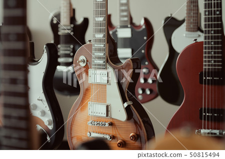 Many electric guitars lined up 50815494
