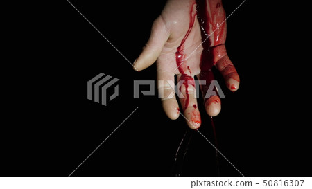 On the human hand, natural blood flows down against a dark background On the human hand, natural blood flows down against a dark background 50816307