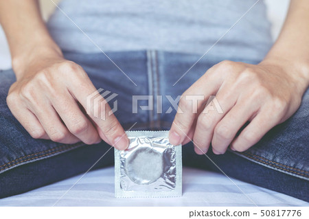 Condoms ready to give in female hand 50817776