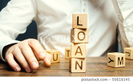 Wooden blocks with the word loan and businessman. Wooden blocks with the word loan and businessman. 50818145