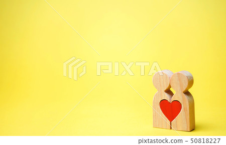A couple in love and a heart between them. A couple in love and a heart between them. 50818227