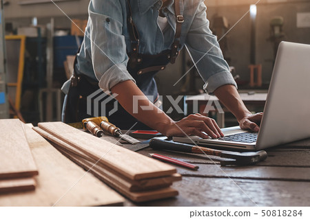 Carpenter working with equipment on wooden table Carpenter working with equipment on wooden table 50818284