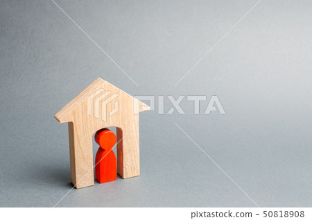 Miniature wooden house with a tenant inside.  50818908