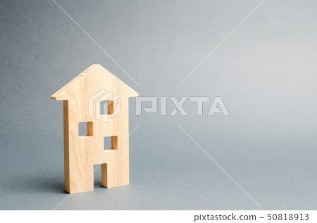 Miniature wooden house on a gray background. 50818913