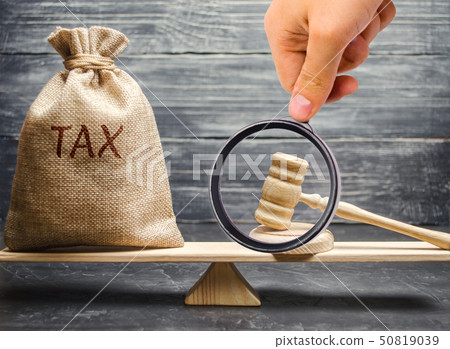 Money bag with the word Tax and hammer judge Money bag with the word Tax and hammer judge 50819039