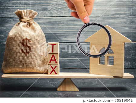 Wooden house and a money bag with the word Tax  50819041