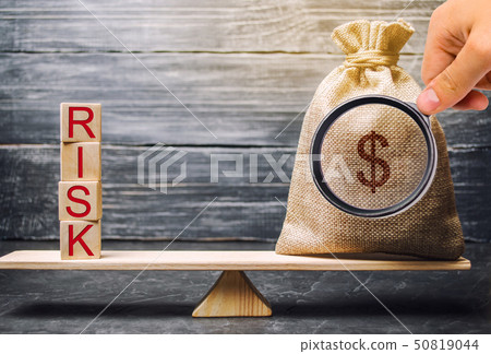 Money bag and wooden blocks with the word Risk. Money bag and wooden blocks with the word Risk. 50819044