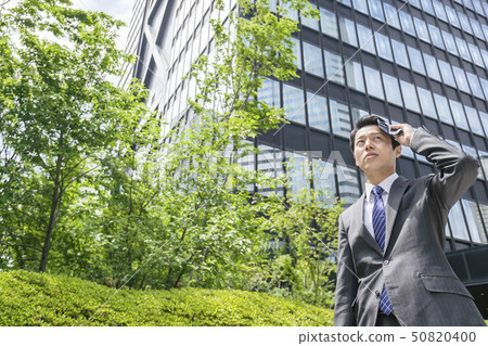 A businessman wiping sweat A businessman wiping sweat 50820400