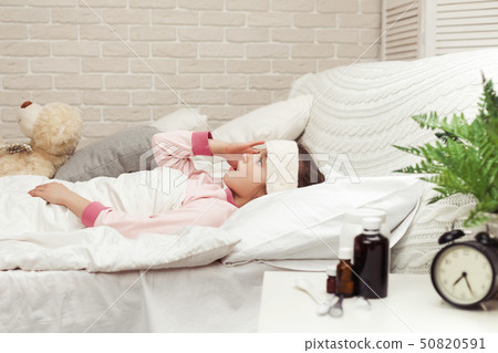 sick cold little child girl lies in bed 50820591