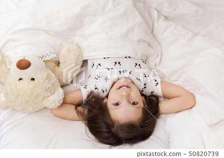 cute little child girl wakes up from sleep cute little child girl wakes up from sleep 50820739
