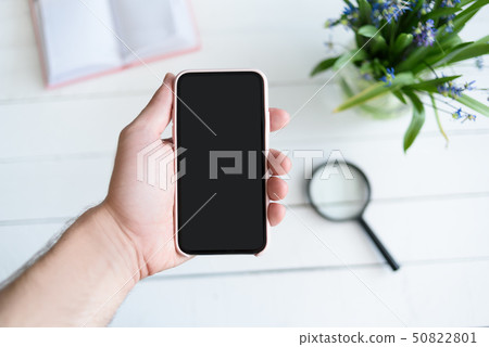 Male hand with a smartphone. Black blank screen. 50822801