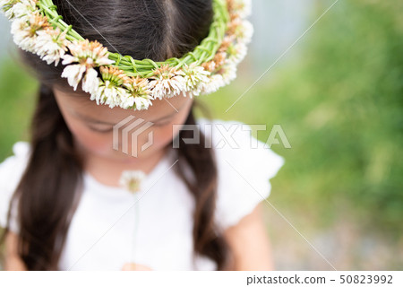 Girl wearing a crown of white clover Girl wearing a crown of white clover 50823992