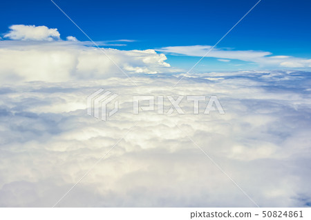 View of the sky clouds above the clouds from airplane window View of the sky clouds above the clouds from airplane window 50824861