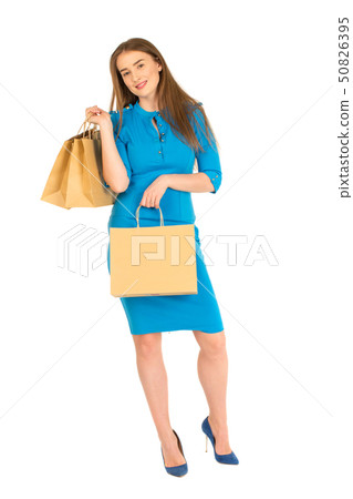 Pretty woman in blue dress posing with bags Pretty woman in blue dress posing with bags 50826395