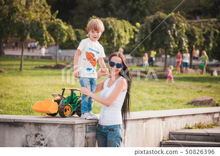 happy family young mother and her five year old son spending time outdoor on a summer day happy family young mother and her five year old son spending time outdoor on a summer day 50826396