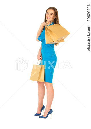 Pretty woman in blue dress posing with bags Pretty woman in blue dress posing with bags 50826398