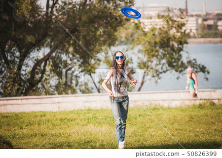 Family playing frisbee on meadow in park Family playing frisbee on meadow in park 50826399