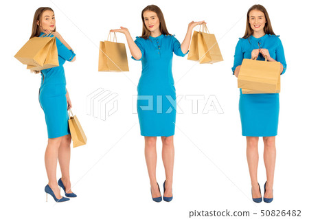 Pretty woman in blue dress posing with set of eco frendly paper bags. Pretty woman in blue dress posing with set of eco frendly paper bags. 50826482