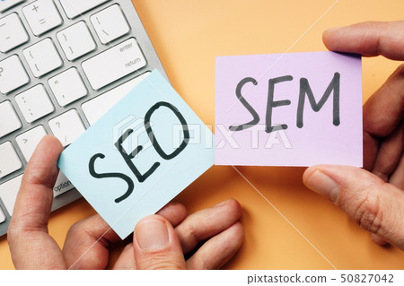 Hands holding cards with SEO and SEM. Hands holding cards with SEO and SEM. 50827042