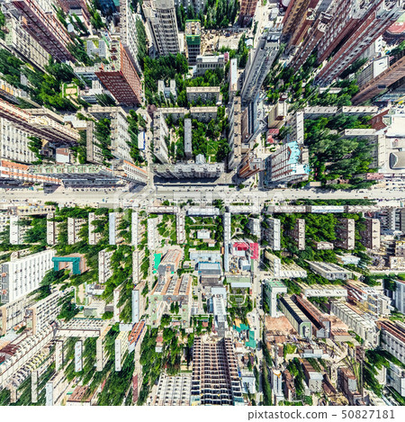 Aerial city view with crossroads and roads, houses, buildings, parks and parking lots. Sunny summer 50827181