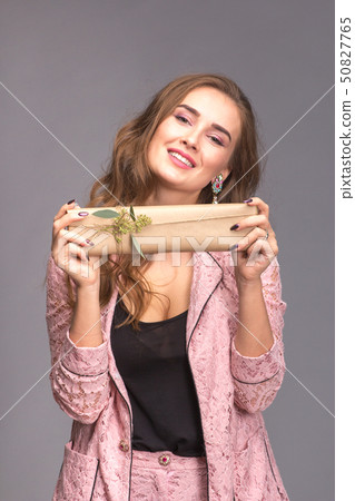 Portrait of a happy woman with gift box  50827765