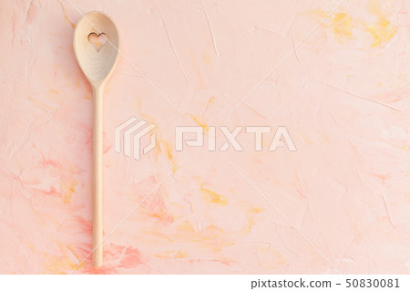 Stirring spoon on a pink background Stirring spoon on a pink background 50830081
