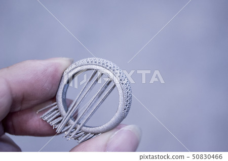 Man is holding object printed on metal 3d printer. Man is holding object printed on metal 3d printer. 50830466