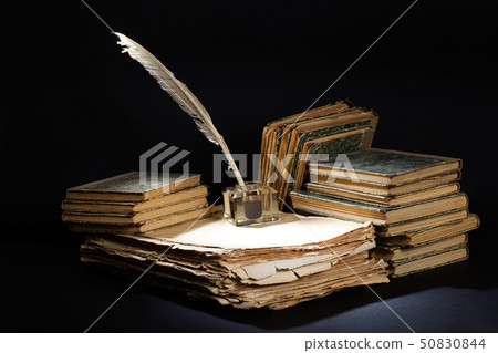 Old vintage fountain pen, books and inkwell on a Old vintage fountain pen, books and inkwell on a 50830844