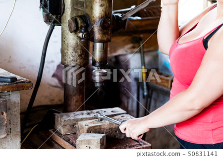 Focused view of a woman holding a knob of a 50831141