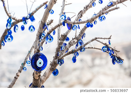 Many Nazar Bonjuu attached to a tree branch 50833697