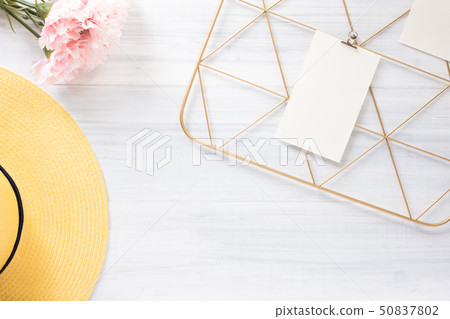 Top view note pad clip frame and summer yellow hat 50837802