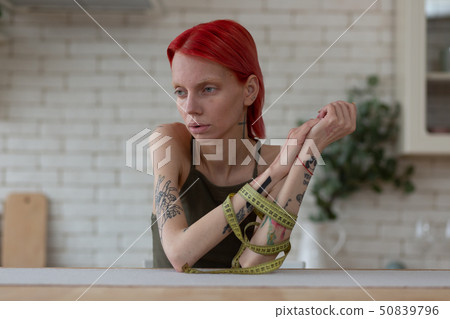 Woman feeling vulnerable suffering from eating disorder 50839796