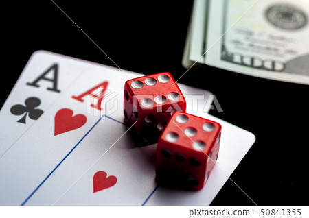 Close-up - Two aces, playing cards and red gaming dices on black table. 50841355