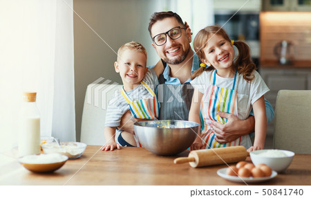 father with children baking cookies father with children baking cookies 50841740