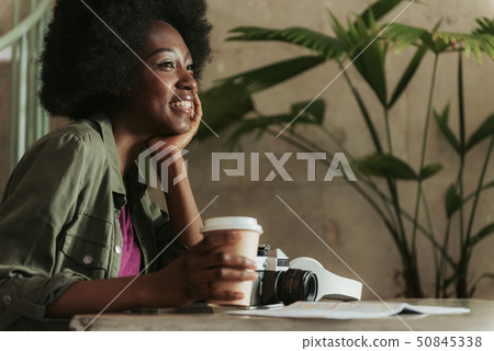 Close up of cheerful young African woman having rest in cafeteria 50845338
