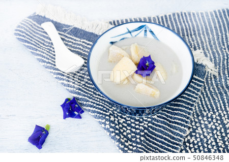 Banana in coconut milk on wooden table.  50846348