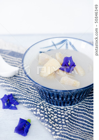 Banana in coconut milk on wooden table. Banana in coconut milk on wooden table. 50846349