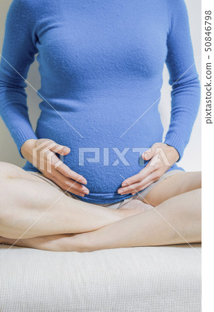 Pregnant woman touching her belly Pregnant woman touching her belly 50846798