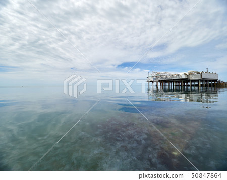 Platform on supports in the sea near the shore. 50847864