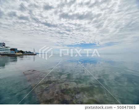 Low dense clouds over the sea.  50847865