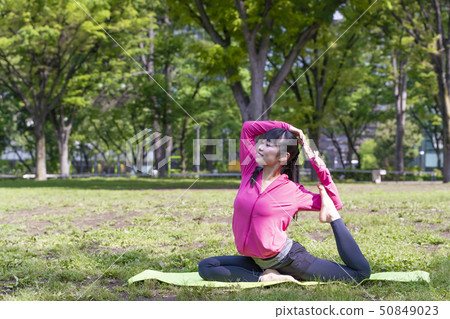 Woman doing yoga in the park 50849023