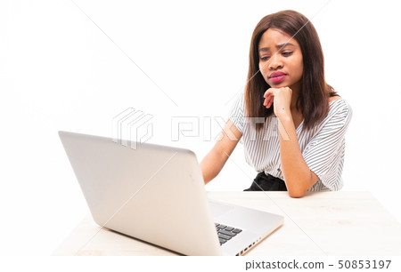 dark-skinned young girl typing on the laptop isolated on background dark-skinned young girl typing on the laptop isolated on background 50853197