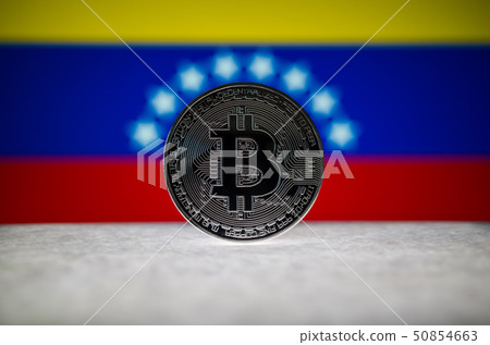 Physical silver version of Bitcoin (BTC) and Venezuela Flag on the background. Conceptual image for Physical silver version of Bitcoin (BTC) and Venezuela Flag on the background. Conceptual image for 50854663