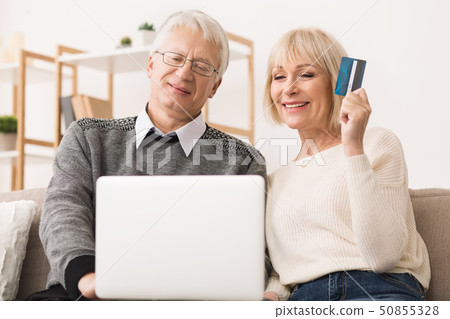 Happy Senior Couple Making Online Purchases On Laptop 50855328